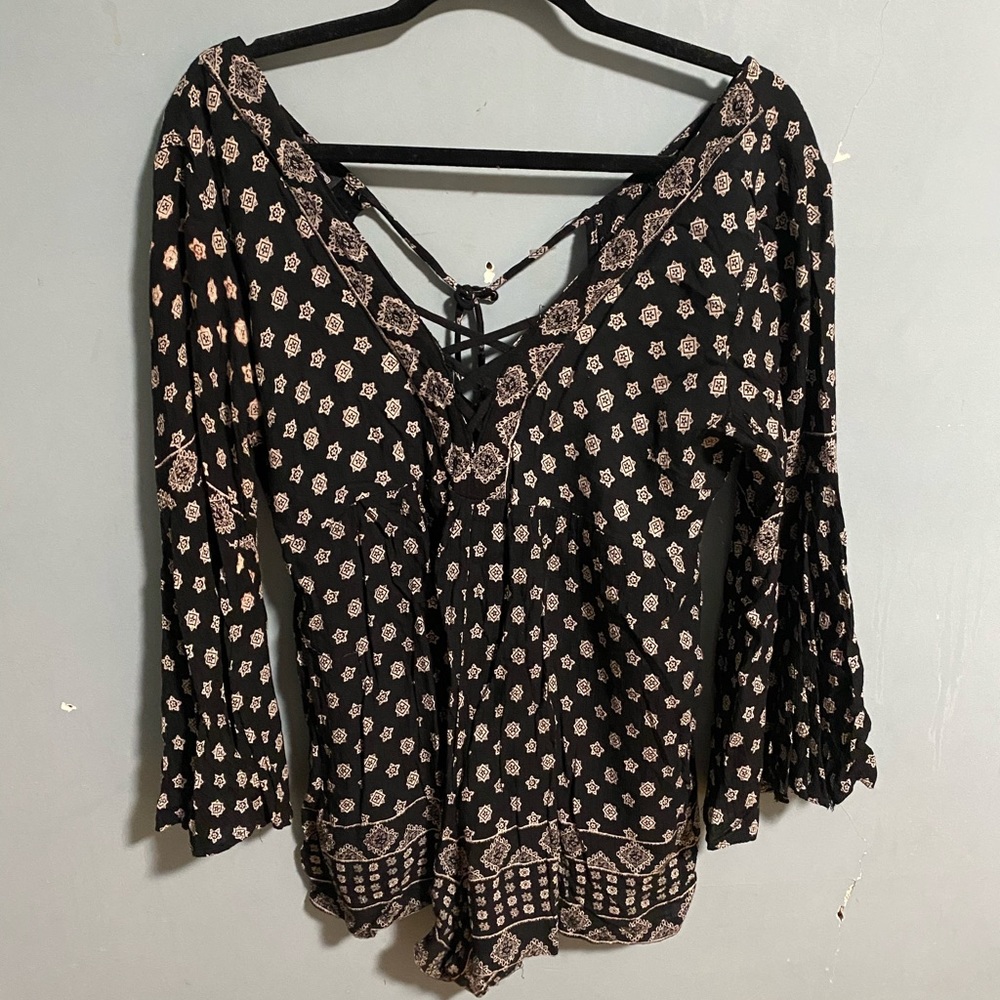 A black and white designed romper